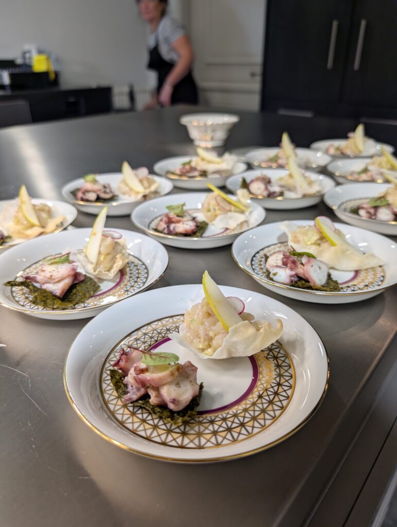 Elisa Girard, private in-home chef in the Loire Valley, preparing a custom gourmet meal for a private function