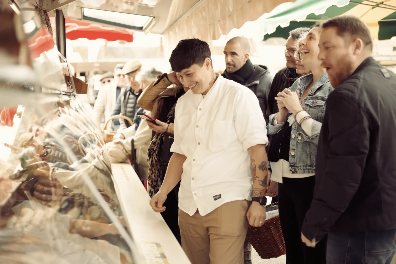 Chef-guide Elisa Girard leads a gourmet stroll through the Bourgueil market during the Loire Valley food tour.